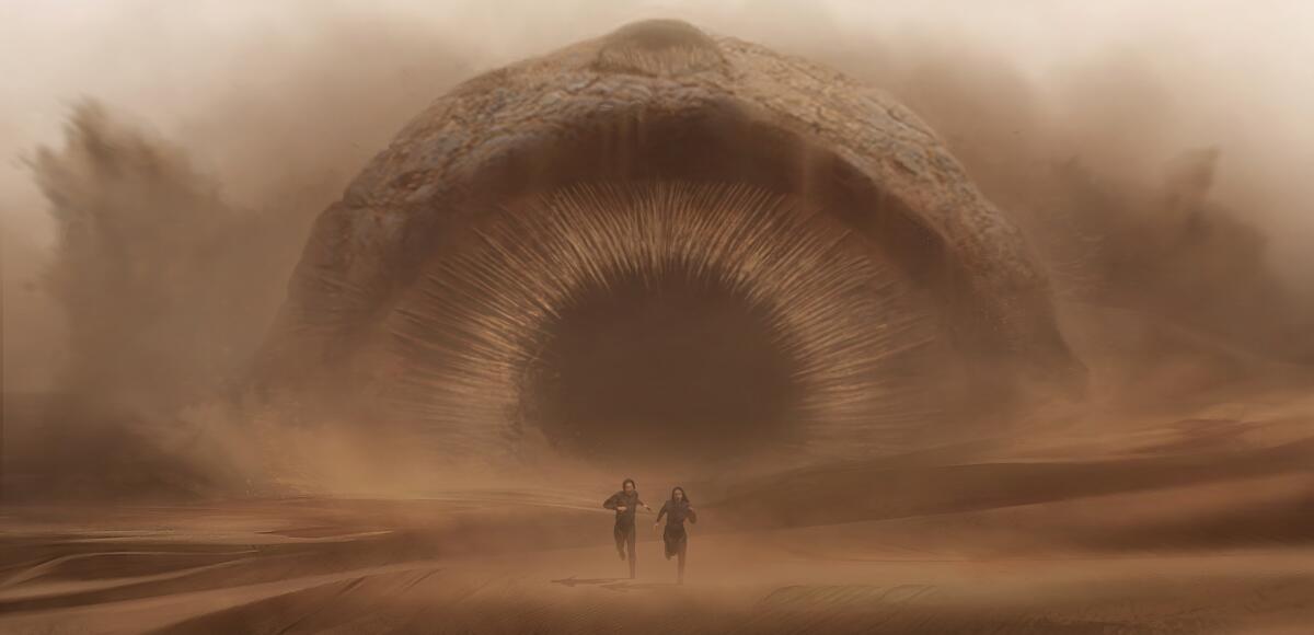 A gigantic, sound-hunting sandworm chases two characters in a scene from "Dune." 