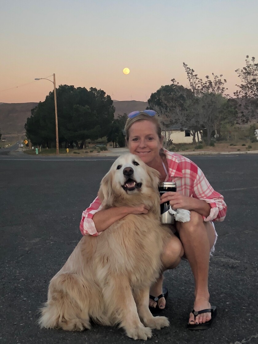 Erin Kelly smiles with Chunks, her popular 10-year-old golden retriever.
