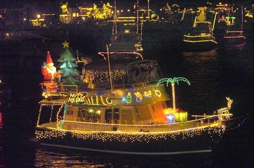 St. Nick waves to spectators from the back of a vessel -- complete with lighted palm tree and reindeer -- at the Newport Harbor Christmas Boat Parade in 2004.