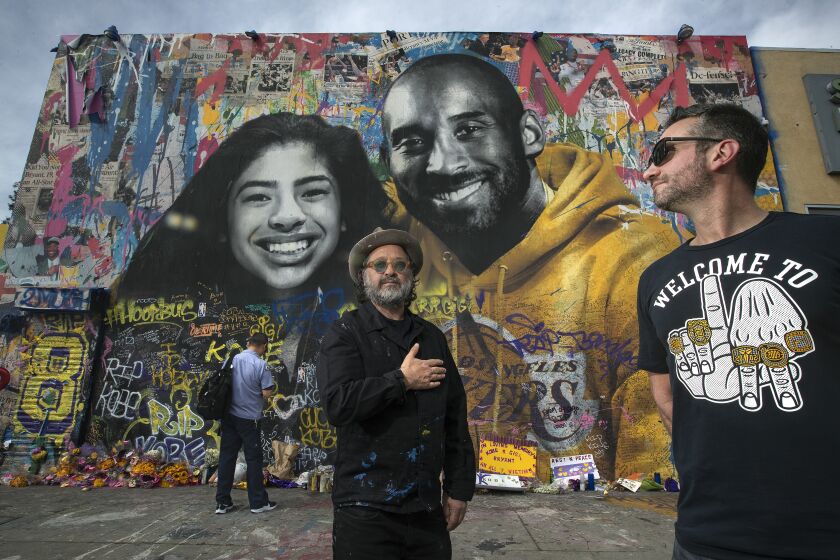 Artist Thierry Guetta, left, and Mike Asner, creator of KobeMural.com, in front of a mural created by Guetta on Feb. 27.