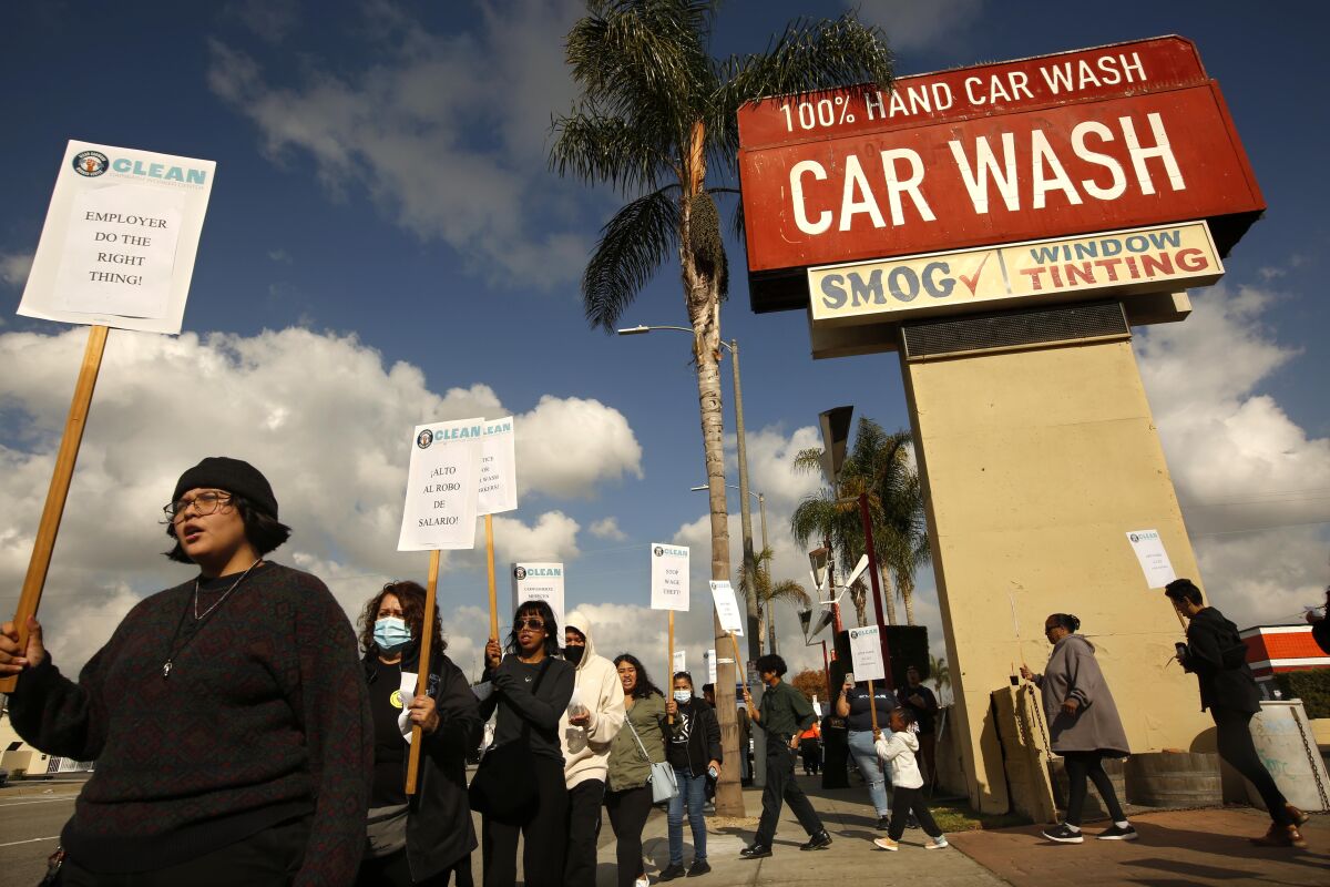 People protest outside a carwash.
