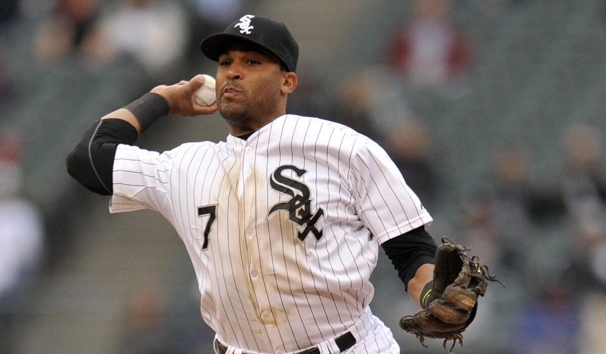Chicago White Sox second baseman Micah Johnson throws to first base against Cincinnati on May 9. On Wednesday, he was part of a three-way trade with the Dodgers.