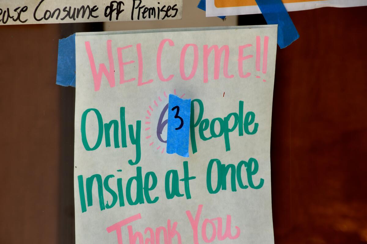 A sign limits foot traffic at the Spoke Bicycle Cafe in Atwater, which is open for take-out orders and bike repairs, but no bike rentals.