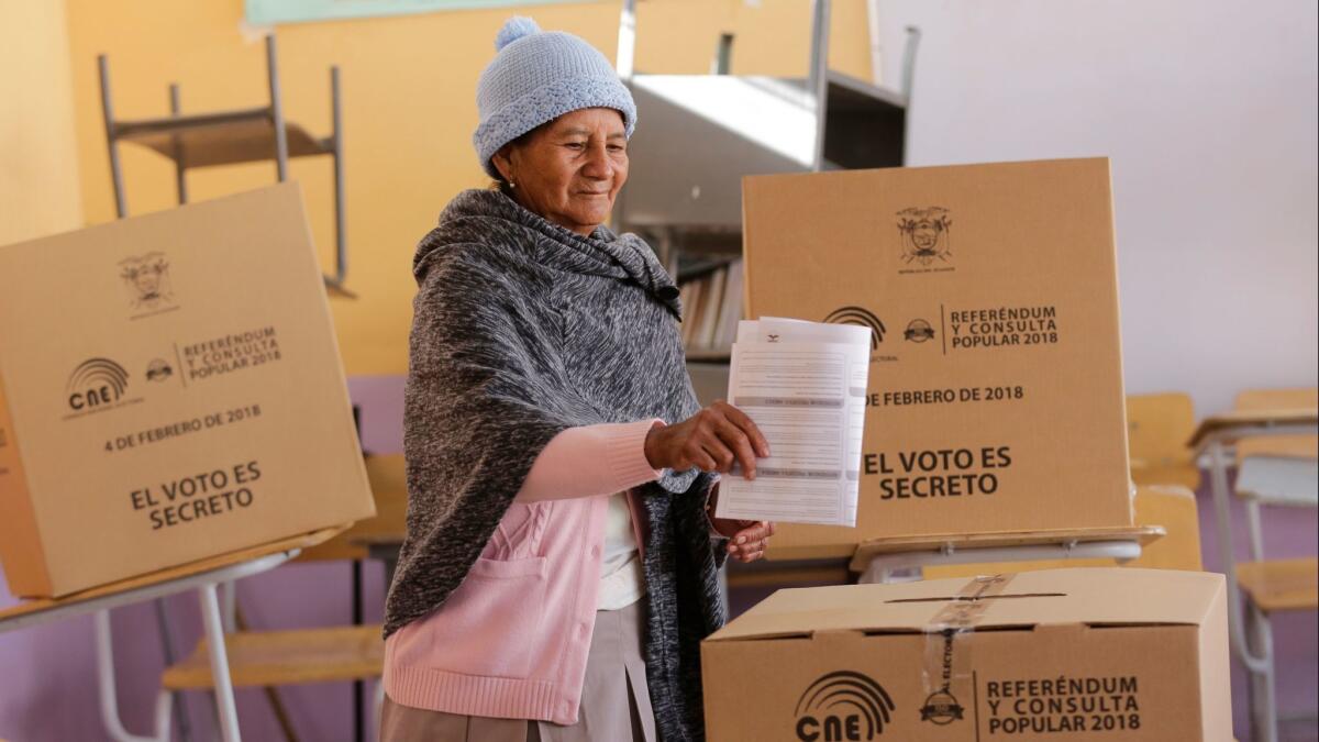 A woman casts her vote on Feb. 4, 2018, in Quito, Ecuador, during a constitutional referendum called by President Lenin Moreno.