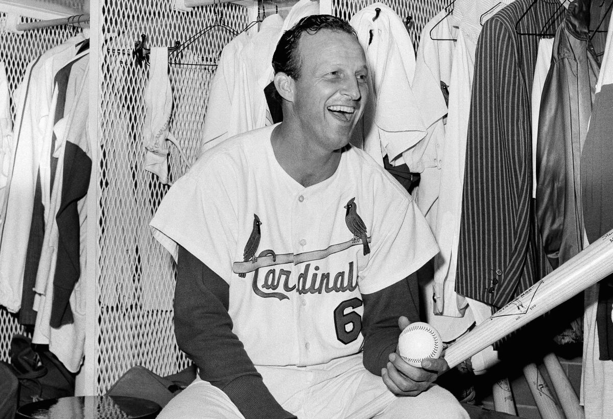 Stan Musial sits in the clubhouse after he tied Babe Ruth's extra-base-hit record, against the Chicago Cubs in St. Louis.