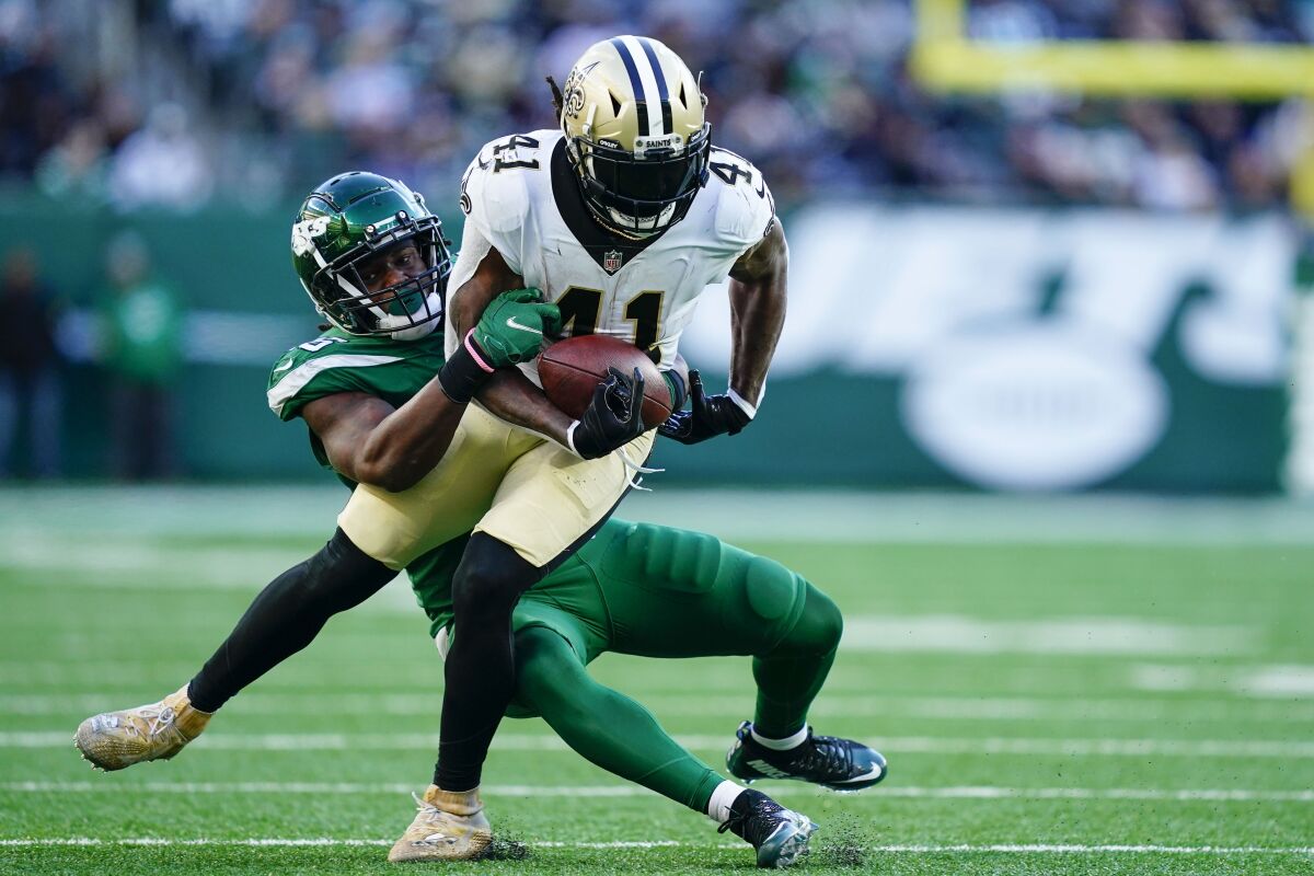 New York Jets linebacker Quincy Williams, left, tackles New Orleans Saints running back Alvin Kamara during the second half.