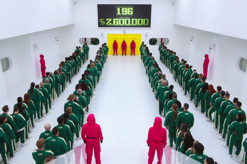 A group of people in track suits in a white room.