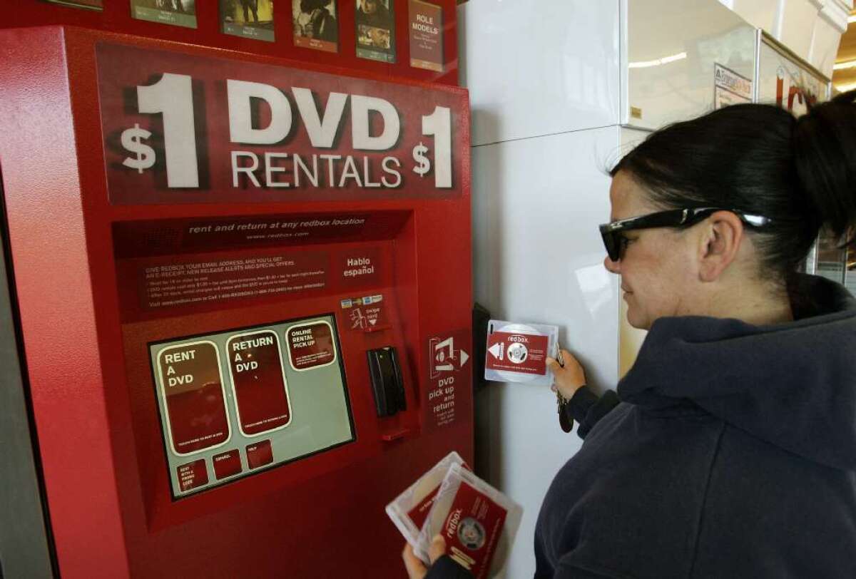 A customer returns DVDs at a Redbox kiosk in Santa Monica.