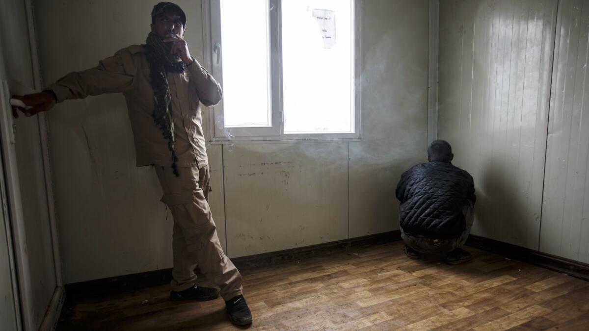 A man suspected of being a member of Islamic State is put in a holding room at a displaced persons camp in Hamam Alil on March 23, 2017.