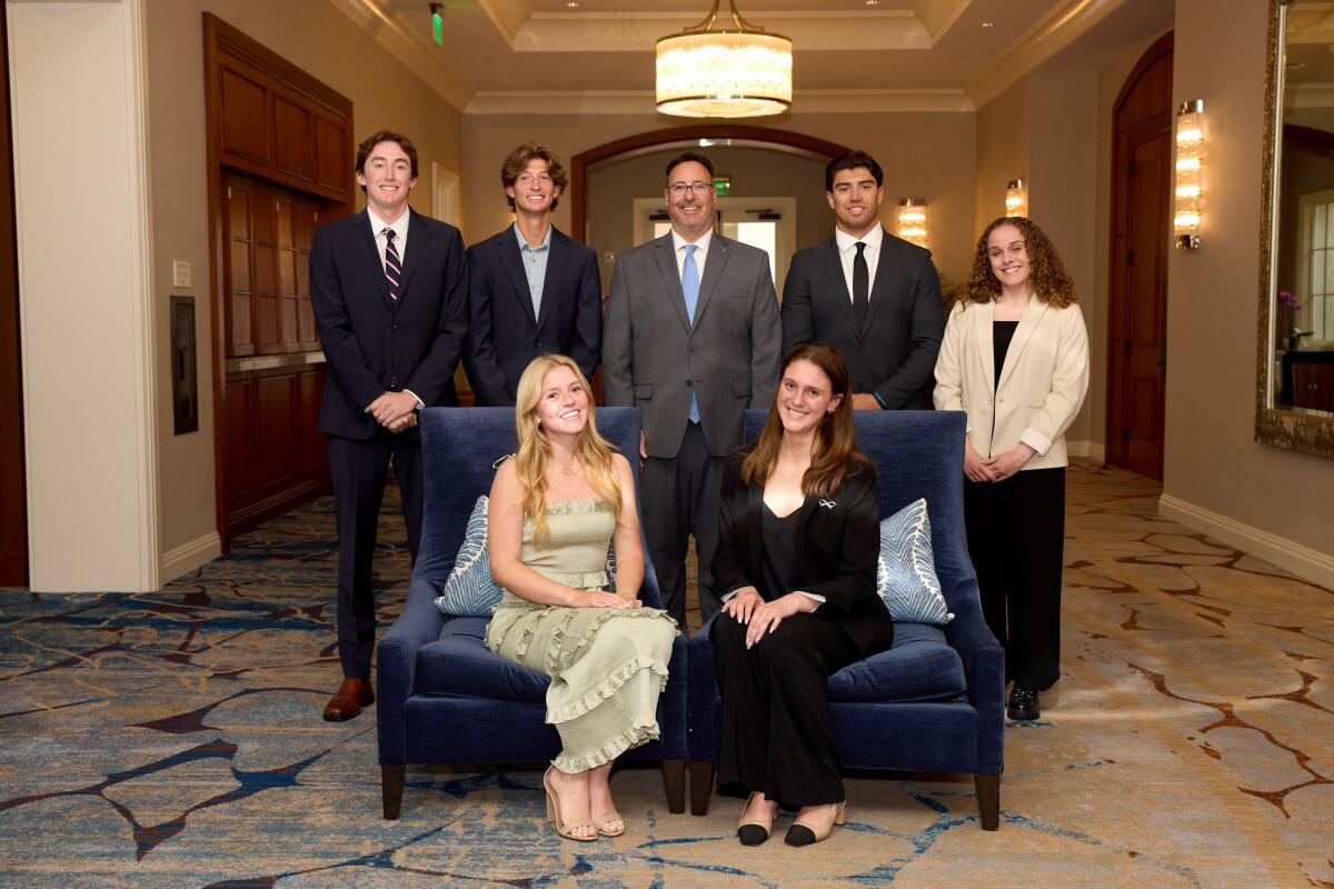 Dr. Jacob Haley, center, stands with 1221 Scholarship winners inside the Balboa Bay Club.