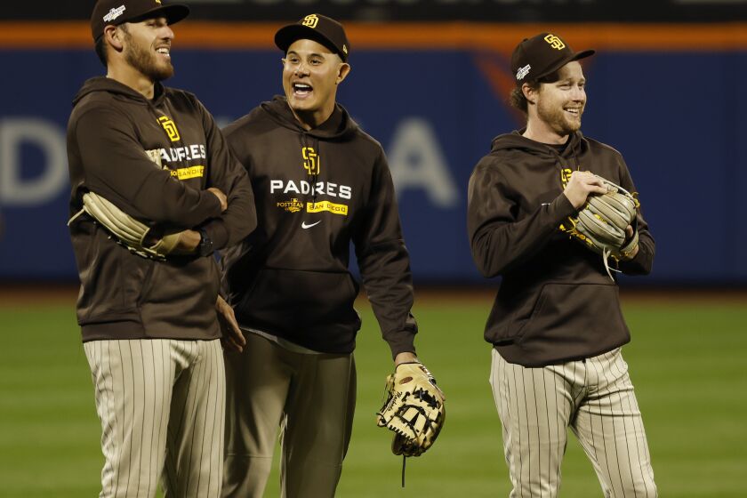 FLUSHING MEADOWS, NY - OCTOBER 6: San Diego Padres' Joe Musgrove, Manny Machado, and Jake Cronenworth laugh during batting practice at Citi Field on Thursday, October 6, 2022 in Flushing Meadows, NY. (K.C. Alfred / The San Diego Union-Tribune)