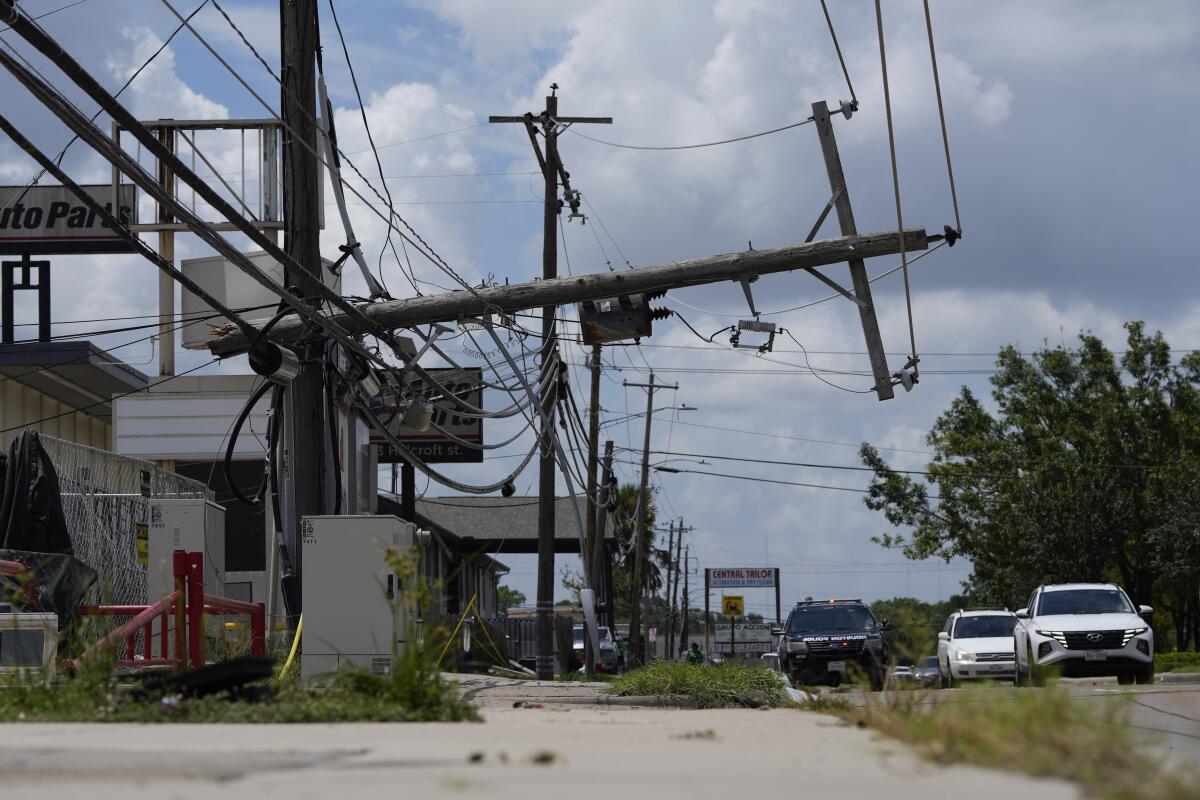 Traffic is directed around a downed power line in Houston.