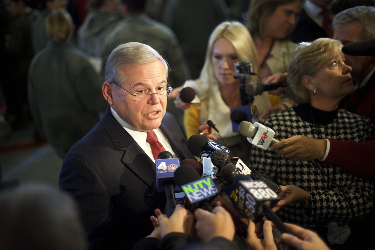 Sen. Robert Menendez speaks to reporters at Joint Base McGuire-Dix-Lakehurst in New Jersey in December.