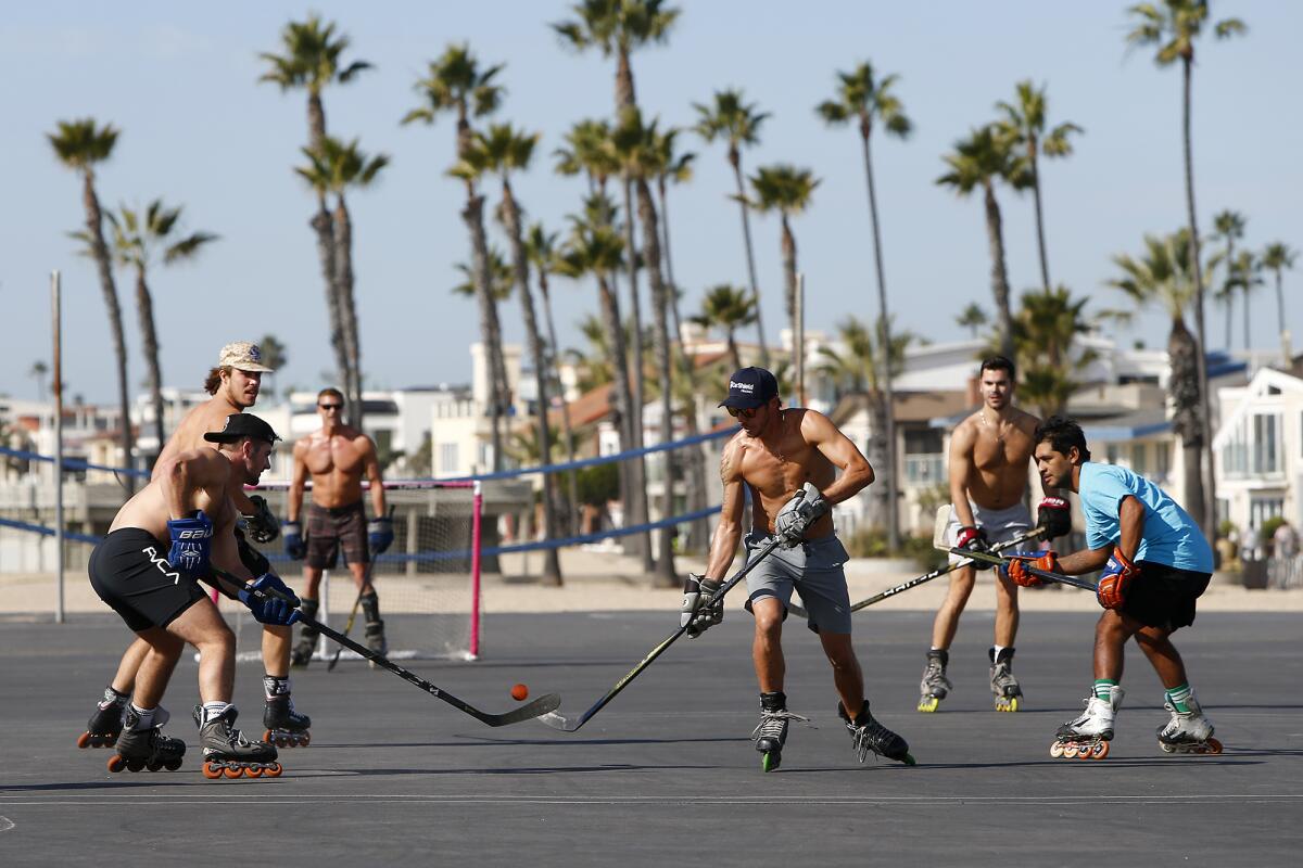 Roller hockey players compete on the blacktop playground at Newport Elementary School in Newport Beach on Saturday.