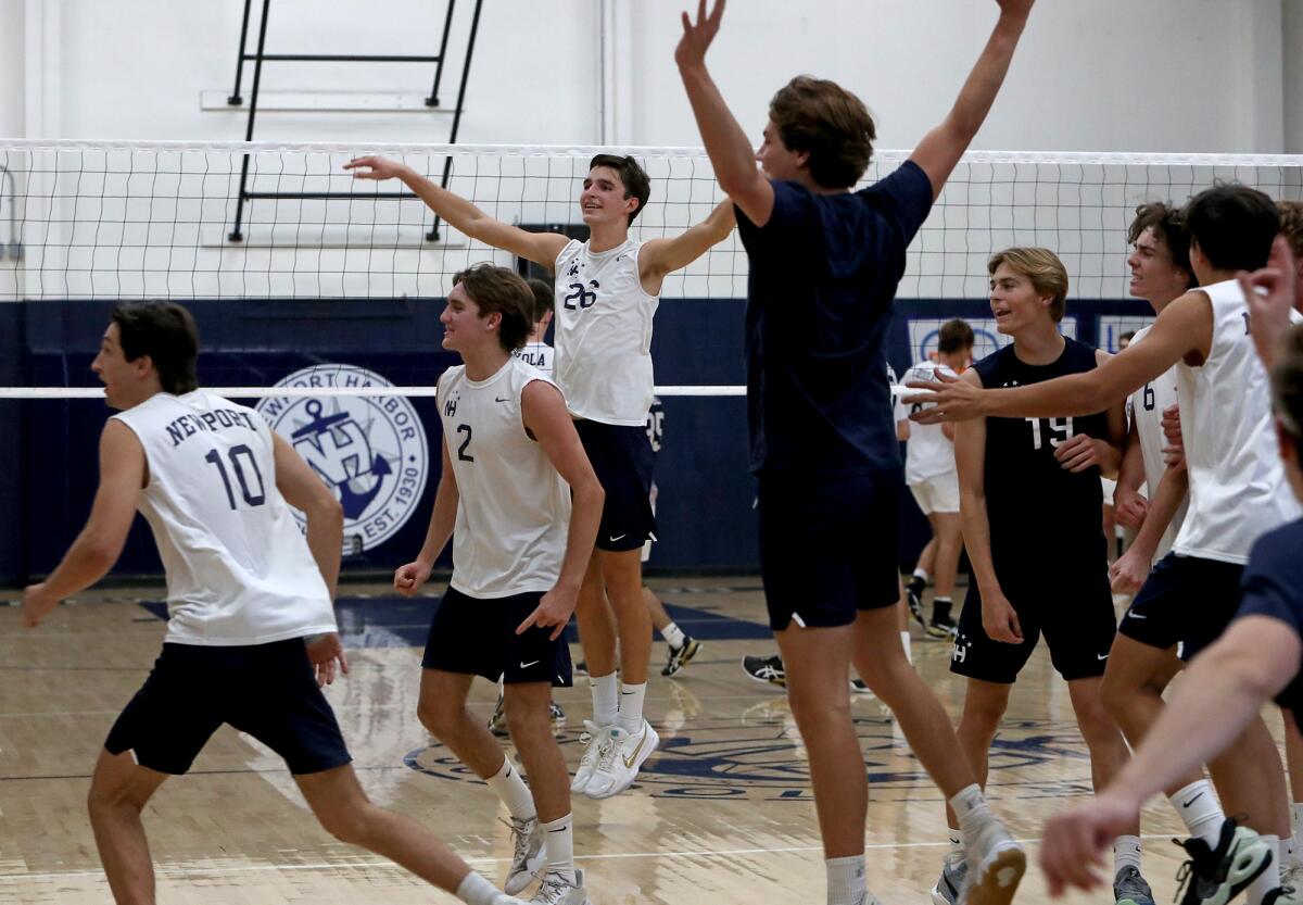Newport Harbor players celebrate upsetting Los Angeles Loyola in the CIF Division 1 boys' volleyball semifinals.
