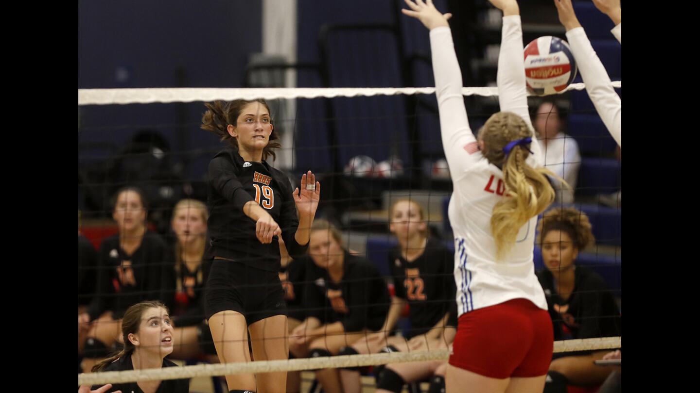 Huntington Beach High's Sabrina Phinizy (19) scores against Los Alamitos during the second set in a Surf League match in Los Alamitos on Wednesday, Sept. 19.