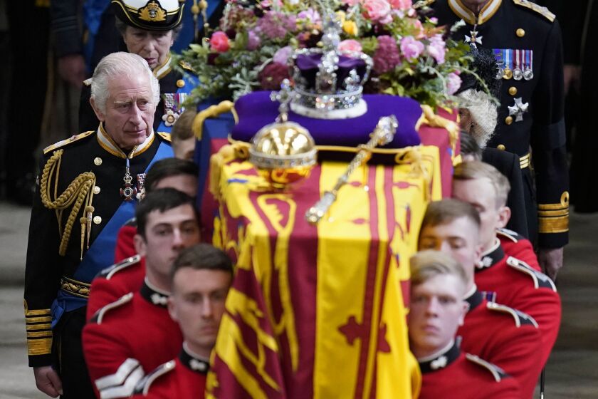 FILE - King Charles III and members of the Royal family follow behind the coffin of Queen Elizabeth II, draped in the Royal Standard with the Imperial State Crown and the Sovereign's orb and sceptre, as it is carried out of Westminster Abbey after her State Funeral, in London, Monday Sept. 19, 2022. The Queen died on Sept. 8 at 96. (Danny Lawson/Pool Photo via AP, File)