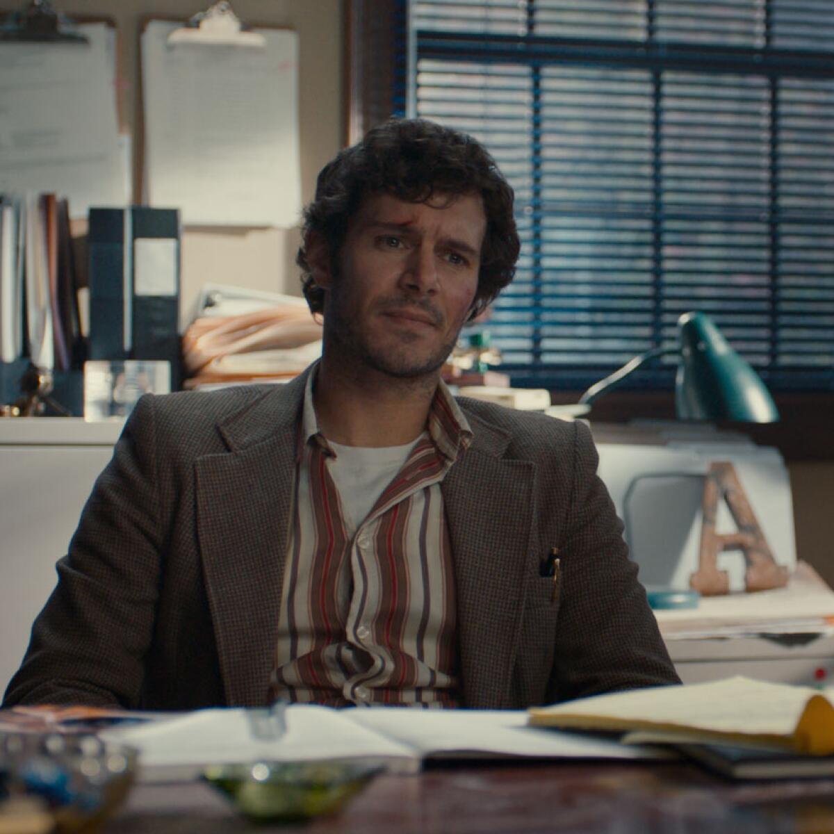 Adam Brody at his PI desk in "The Kid Detective."