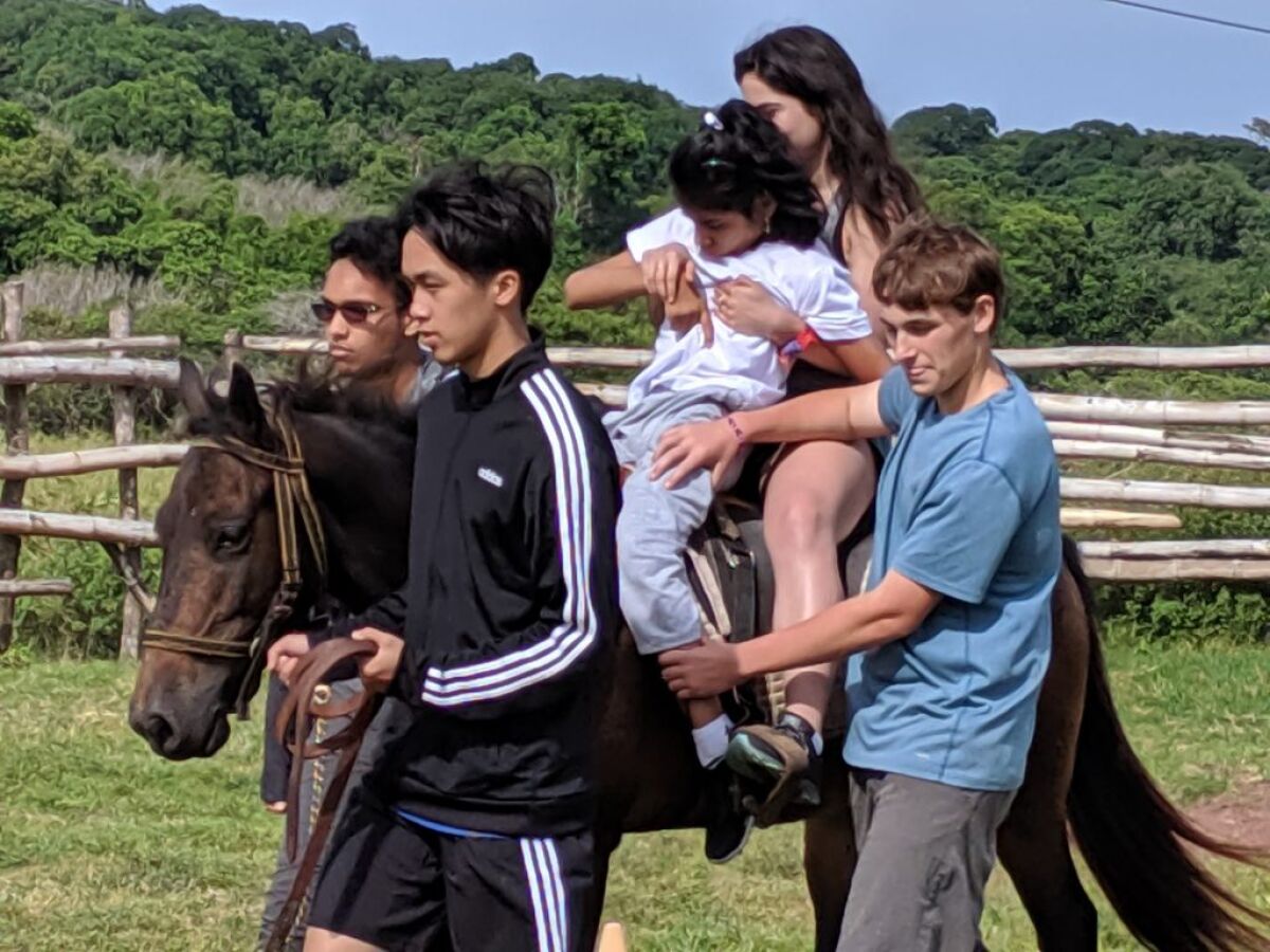 Pacific Ridge students visited the Galapagos Islands to participate in service work, including equine therapy with disabled children.