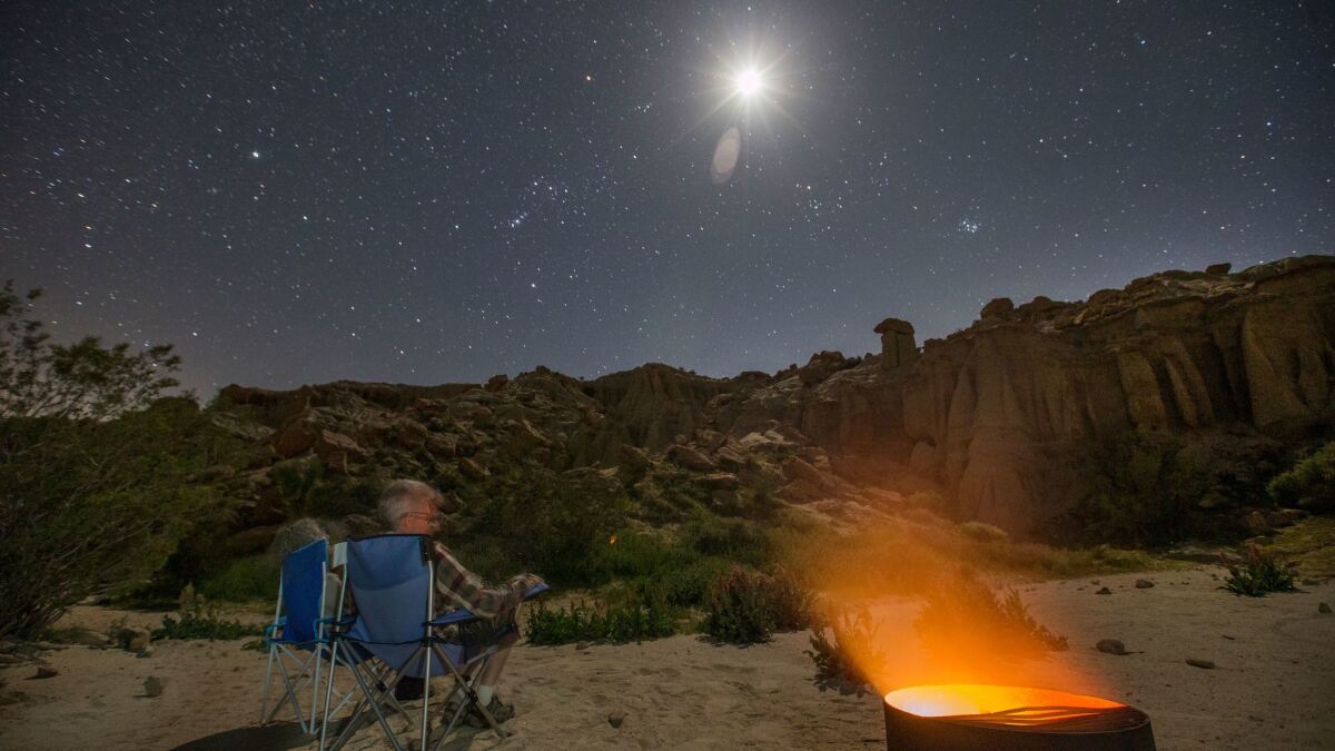 A traveler enjoys a clear night at a desert campground in California. It's the sort of attraction that likely helped the Golden State in the road trip study.