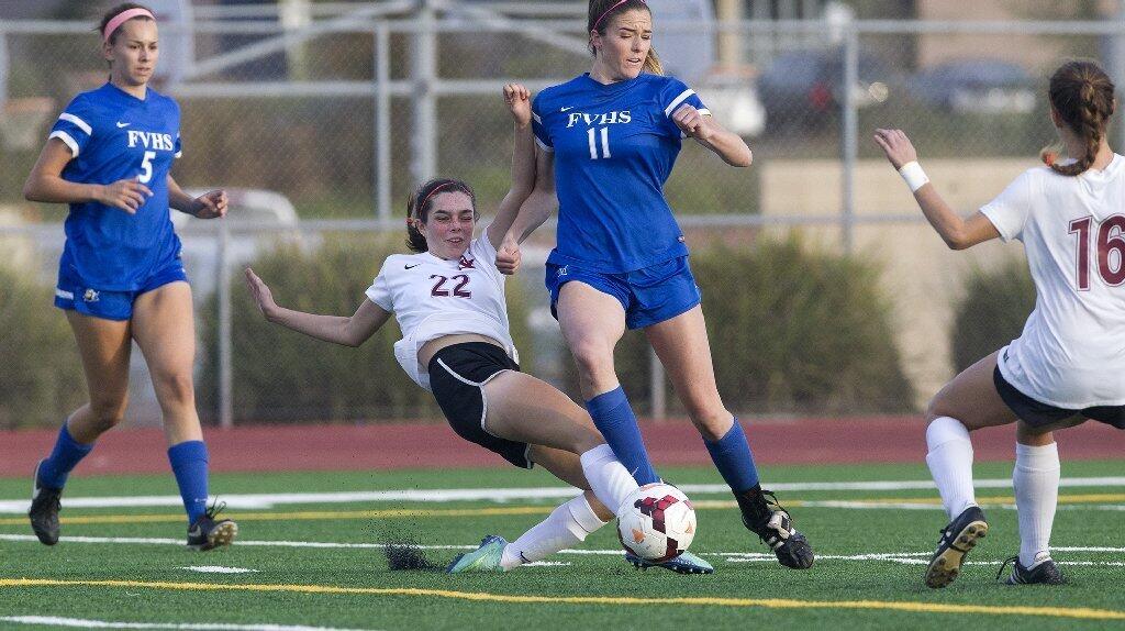 Ocean View High's Analisa Chavez (22) battles Fountain Valley's Allison Bebout (11) for a loose ball.