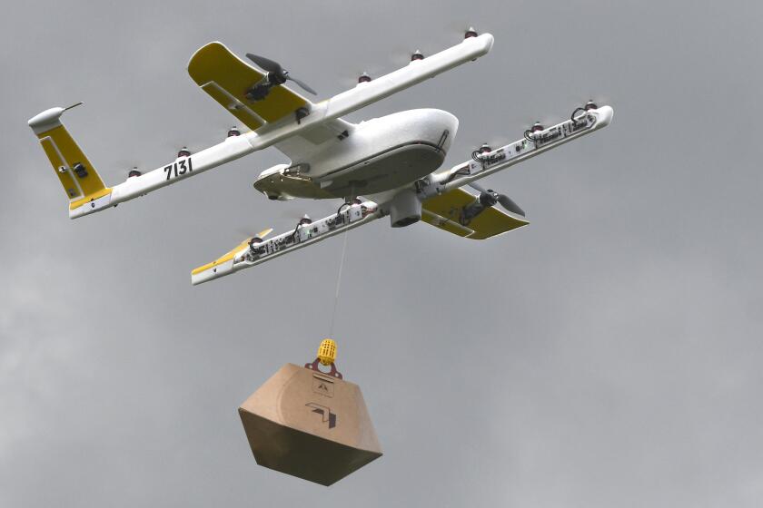 In this Tuesday, Aug, 7, 2018, photo a Wing Hummingbird drone carries a package of ice cream and popsicles as it leaves its launch site during a delivery flight demonstration in Blacksburg, Va. Wing, a subsidiary of Google's parent corporation Alphabet, hasn't been allowed to fly long distances, over people and beyond the pilot's line of sight. That changed when Virginia was selected as one of 10 areas to participate in an experimental program that would lower barriers on the technology. (Michael Shroyer via AP)