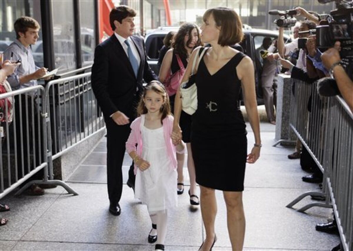 FILE - In this July 26, 2010, file photo, former Illinois Gov. Rod Blagojevich, left, and his wife Patti, right, arrive at the federal courthouse with their daughters Annie, front holding Patti's hand, and Amy, in Chicago, during his first trial on corruption charges. Convicted on multiple counts of corruption, Blagojevich is scheduled for his sentencing hearing beginning Tuesday, Dec,. 6, 2011, at federal court in Chicago. (AP Photo/M. Spencer Green, File)