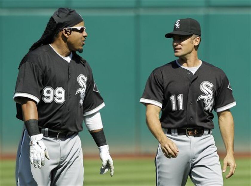 Chicago White Sox's Manny Ramirez (99) talks with Omar Vizquel before a baseball game against the Cleveland Indians, Wednesday, Sept. 1, 2010, in Cleveland. (AP Photo/Mark Duncan)