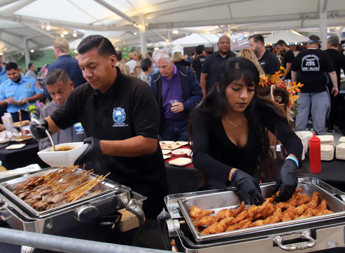 Beef skewers and coconut shrimp prepared by cooks from the Cliff restaurant during the Taste of Laguna on Thursday.