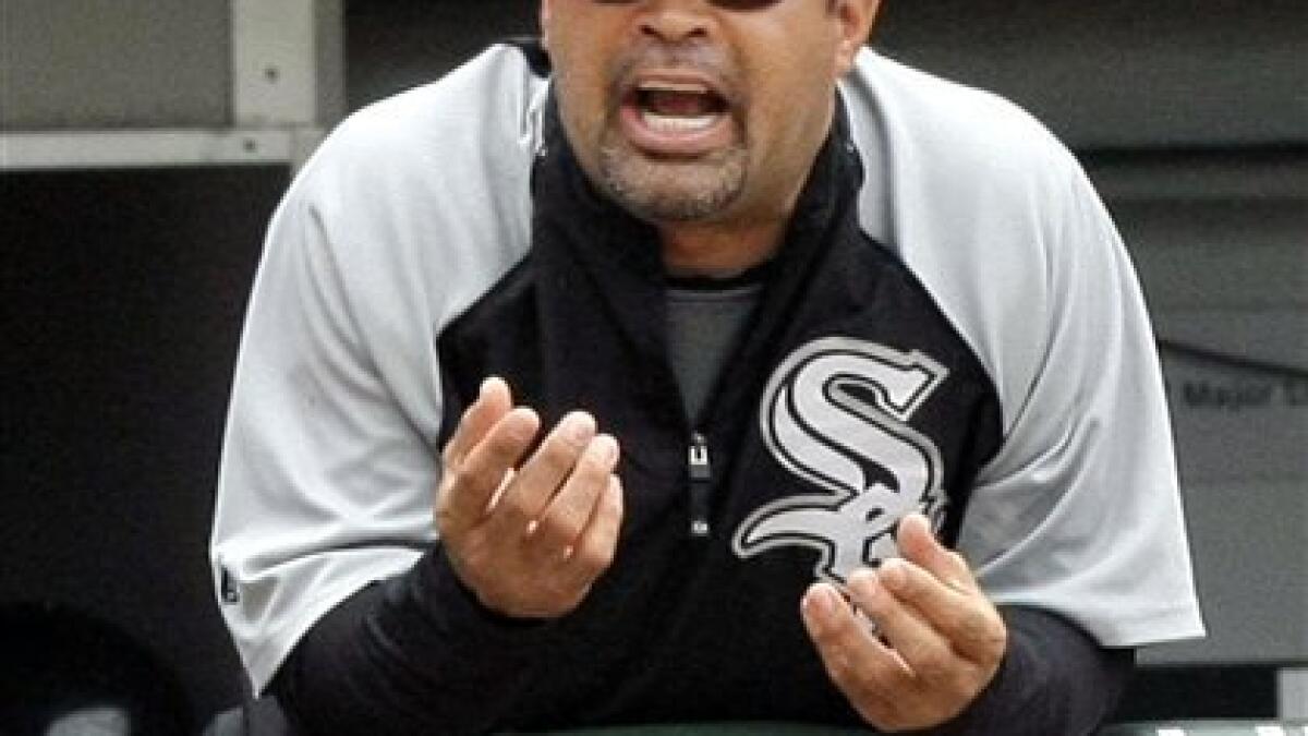 Chicago White Sox manager Oswaldo Ozzie Guillen waves to fans as his wife  Ibis stands behind him at University stadium before a national baseball  league game in Caracas, Venezuela, Friday, Nov. 4