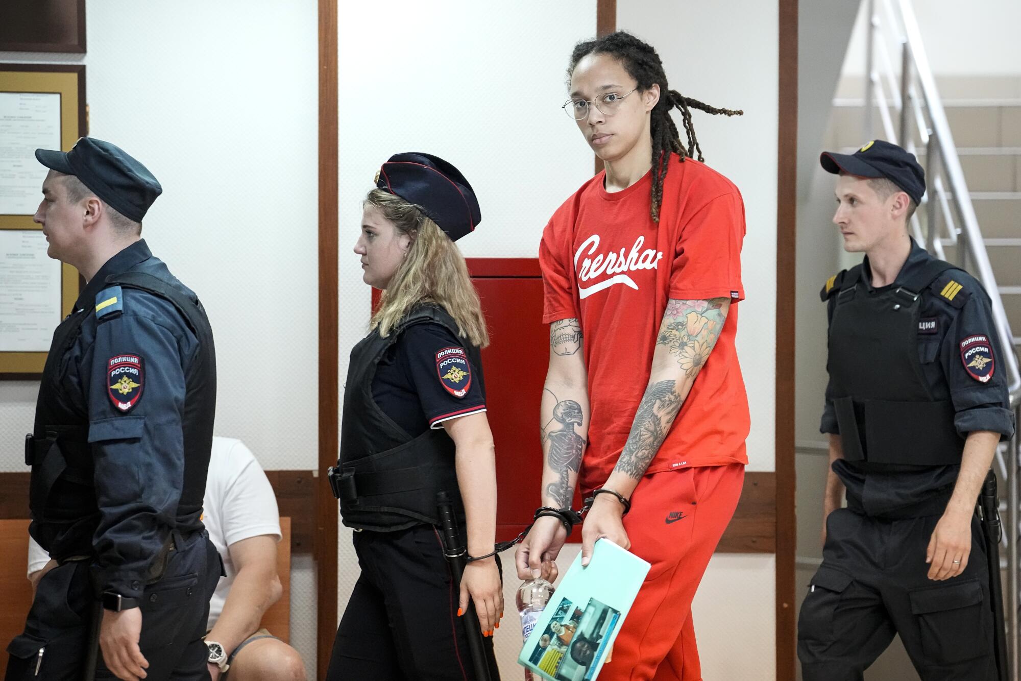 Brittney Griner is escorted to a courtroom in Khimki, outside Moscow.