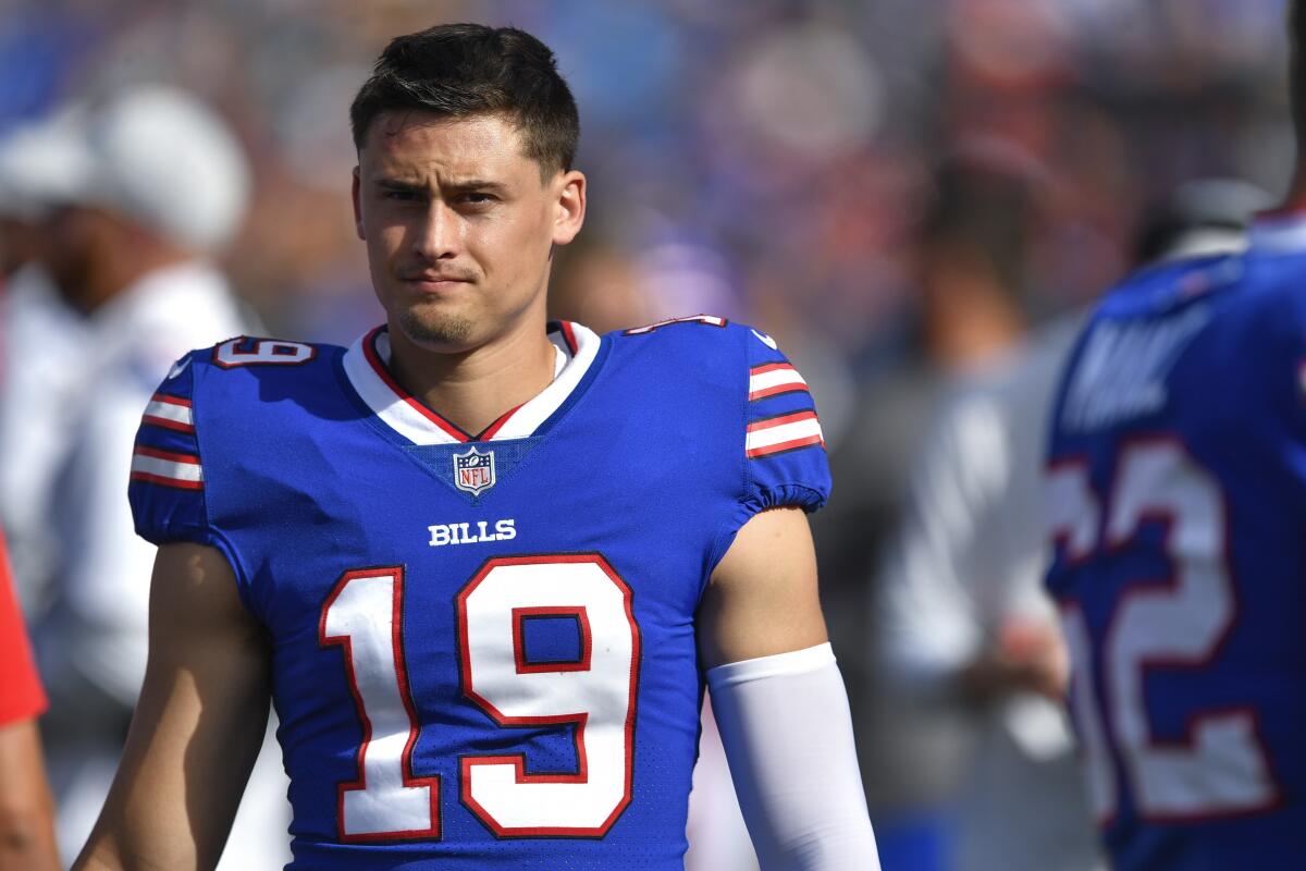 Buffalo Bills punter Matt Araiza walks on the sideline during a preseason game.