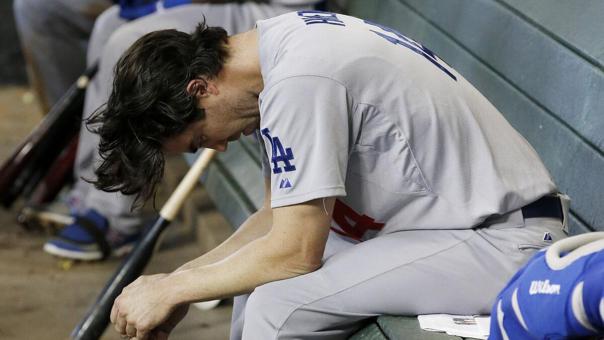 Dodgers starting pitcher Dan Haren sits in the dugout after giving up a two-run home run to Arizona's Eric Chavez during the Dodgers' 5-3 loss Sunday.