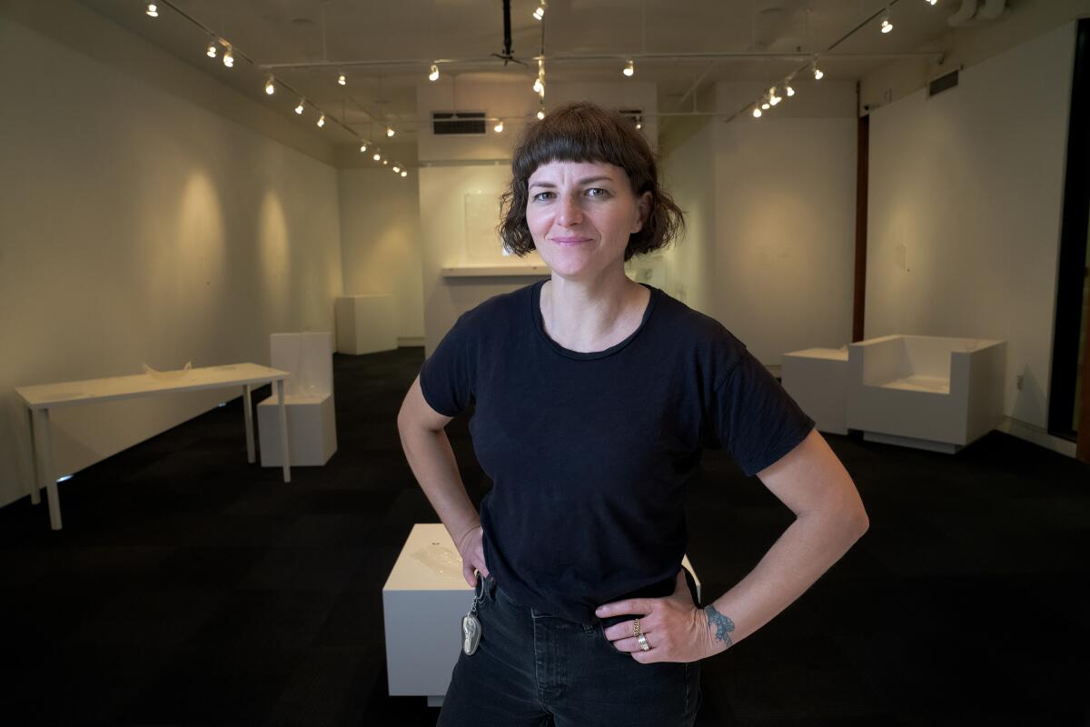 Artist-in-residence Kerianne Quick at her exhibit, "A Portrait of People in Motion," at the New Americans Museum at Liberty Station.