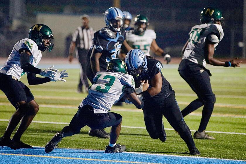 Carson fullback Brendan Fautua Leomiti barrels over Narbonne safety Triston Thomas.