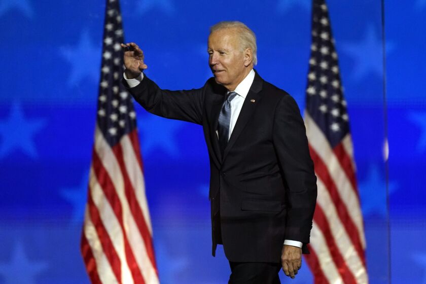 Democratic presidential candidate former Vice President Joe Biden waves to supporters, Tuesday, Nov. 3, 2020, in Wilmington, Del. (AP Photo/Andrew Harnik)