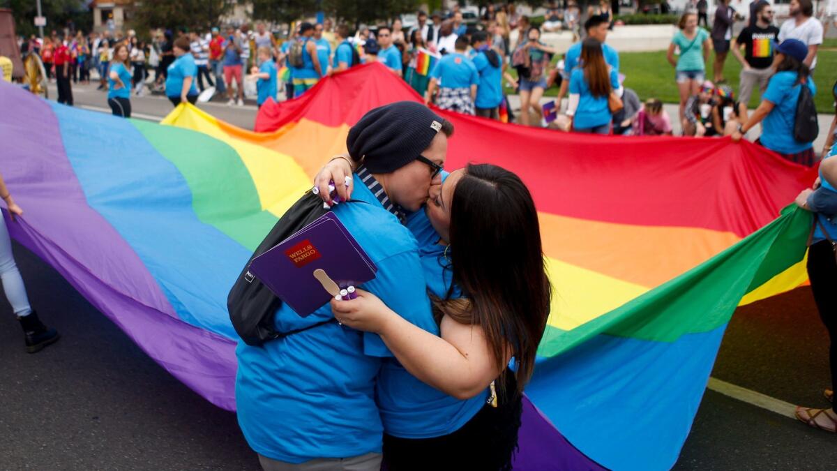 Lulu Garcia and Dani Garcia kiss during the annual L.A. Pride Parade in West Hollywood in 2016.