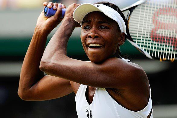 Venus Williams returns a ball during a second-round match at the All England Club. Wimbledon, the third Grand Slam tournament of 2009, runs to July 5.