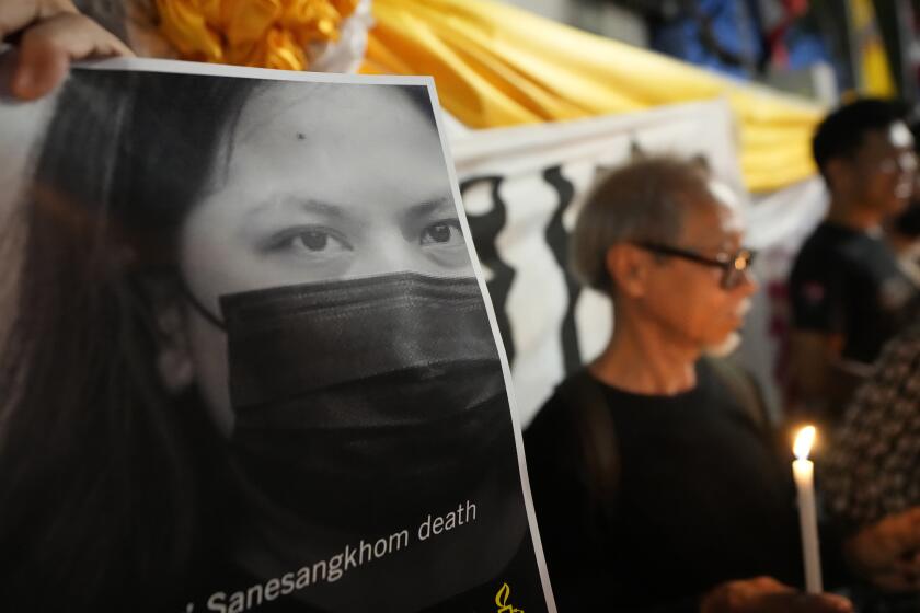 FILE - Thai activists hold a portrait of Netiporn Sanesangkhom, a member of the activist group Thaluwang, known for their bold and aggressive campaigns demanding reform of the monarchy and abolition of the law that makes it illegal to defame members of the royal family outside of Criminal court in Bangkok, Thailand, on May 14, 2024. Thailand's prime minister on Wednesday, May 15, 2024 offered his condolences to the family of the young activist who died in detention after a months long hunger strike, amid a spark of public debate on the country's justice system. (AP Photo/Sakchai Lalit, File)