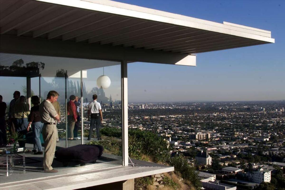 Visiting preservationists and architects enjoy the view from Case Study House No. 22 in the Hollywood Hills.
