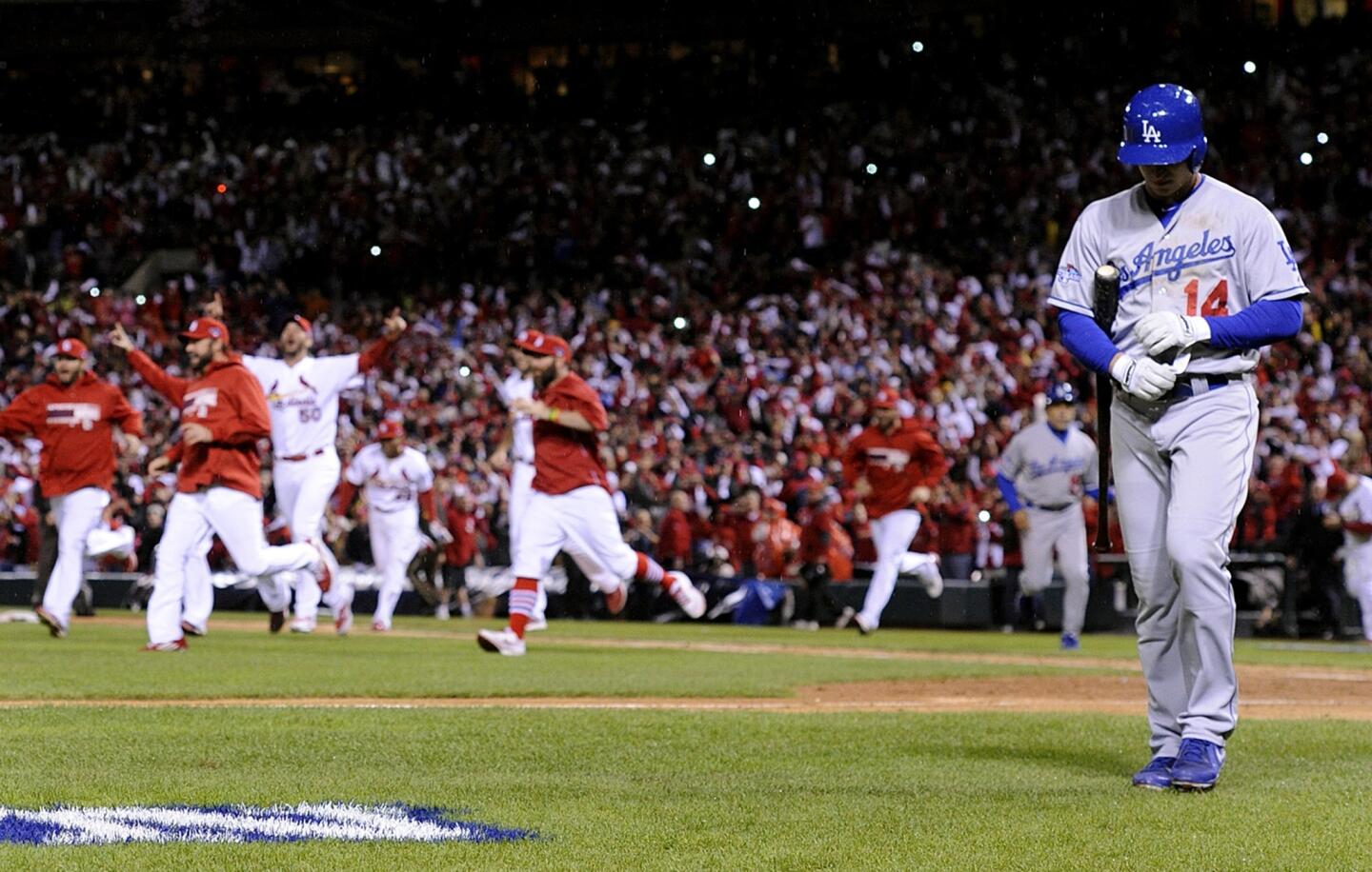 Dodgers second baseman Mark Ellis walks off the field after striking out to end the game as the St. Louis Cardinals celebrated their 9-0 win in Game 6 of the NLCS.