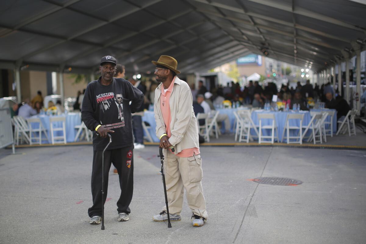 Felton Pierce, left, and Eric Dyer, who are both homeless, talk ahead of a visit by Pope Francis to a lunch for the homeless who are served by Catholic Charities in Washington. (Brian Snyder/Pool Photo via AP)