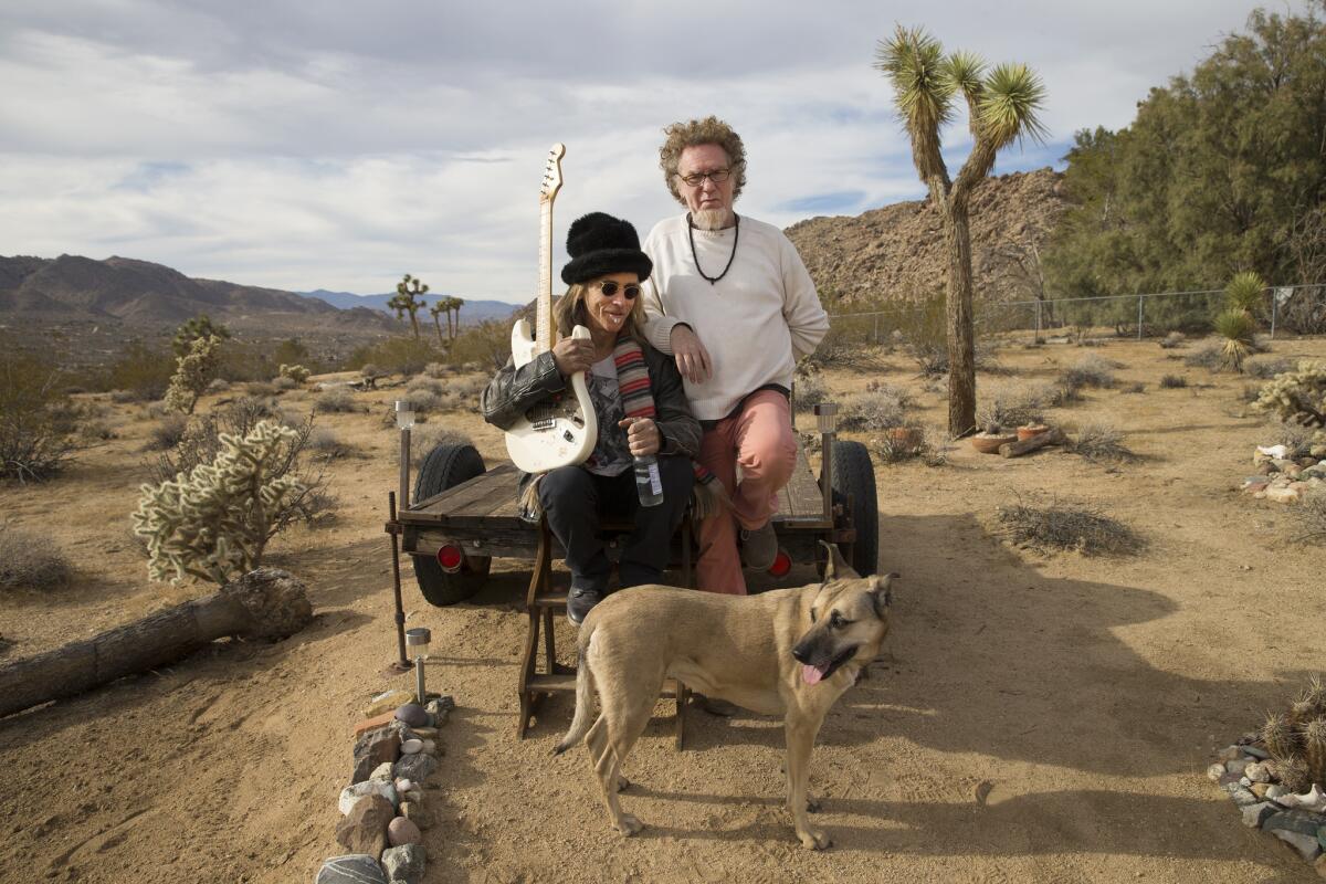 Joshua Tree musicians Robbi Robb, right, and Ted Quinn, and his dog, Rose, live in the desert and epitomize the desert music scene.