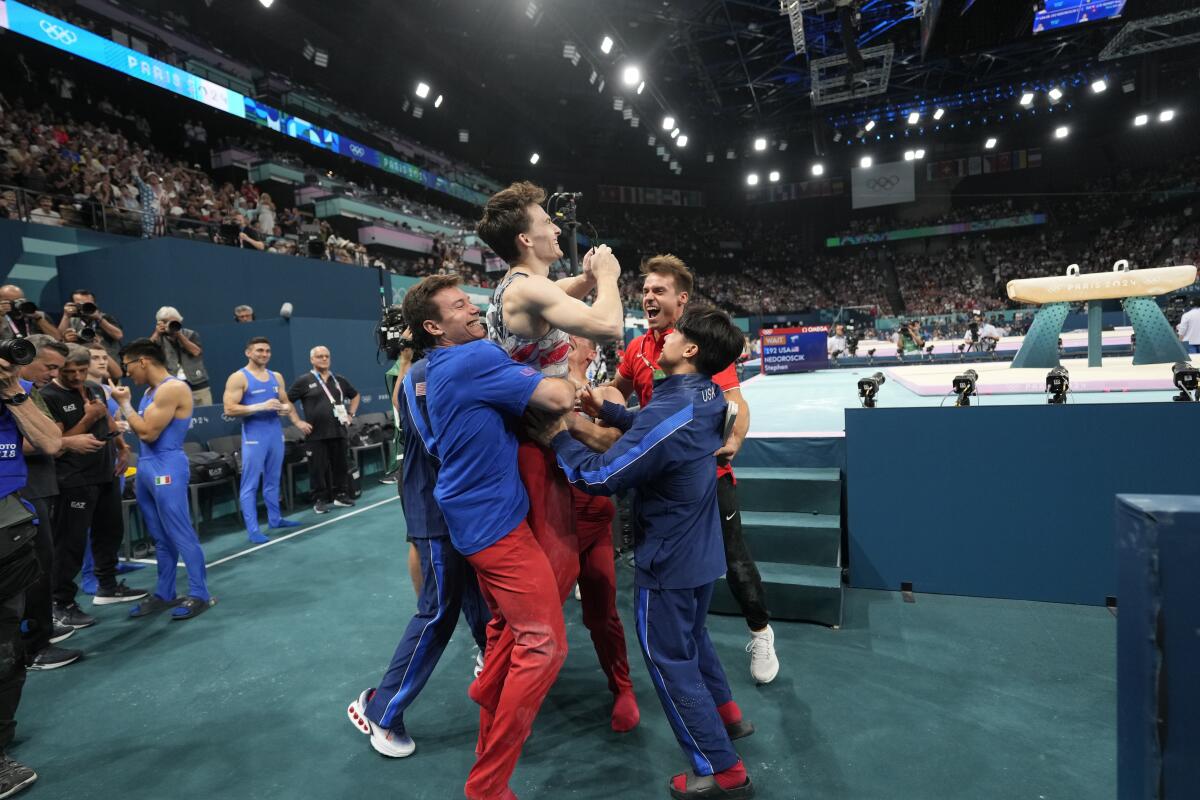 American Stephen Nedoroscik is lifted by teammates after nailing his pommel horse routine 
