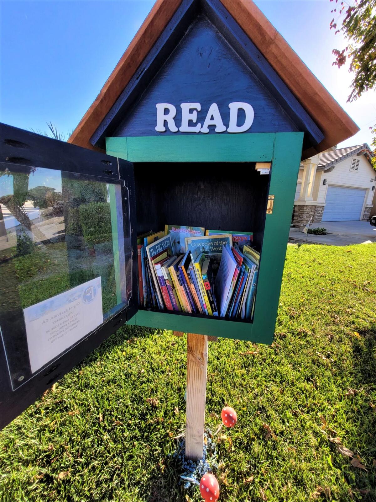 Books "rescued" by the Butterfly Book Project often find their way into Little Free Libraries, like this one in Corona.