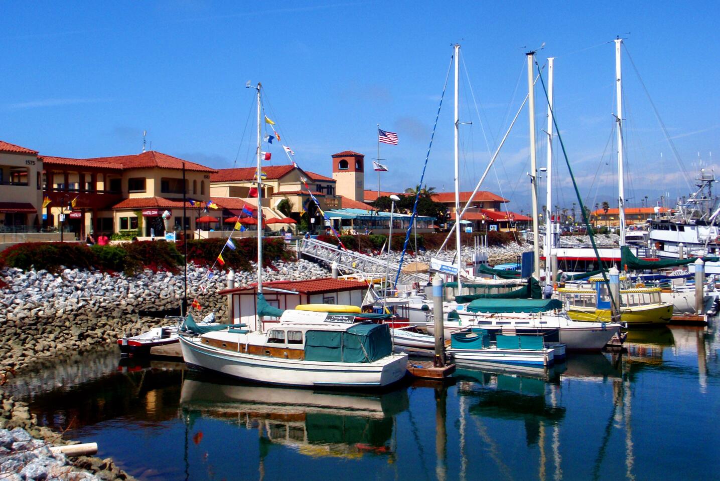 The boating and harbor life is all around the Ventura area. Here Ventura Harbor reflects the boats with a floating B&B in the foreground.