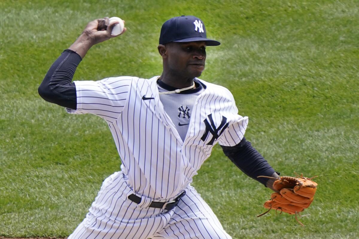 New York Yankees starting pitcher Domingo German (55) winds up during the first inning of a baseball game against the Toronto Blue Jays, Sunday, April 4, 2021, at Yankee Stadium in New York. (AP Photo/Kathy Willens)