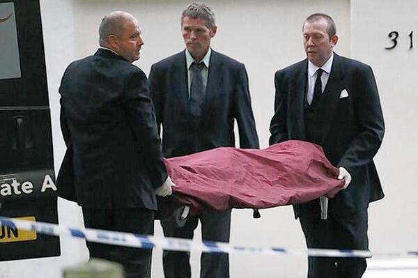 Funeral workers carry the body of Amy Winehouse outside her house in London.