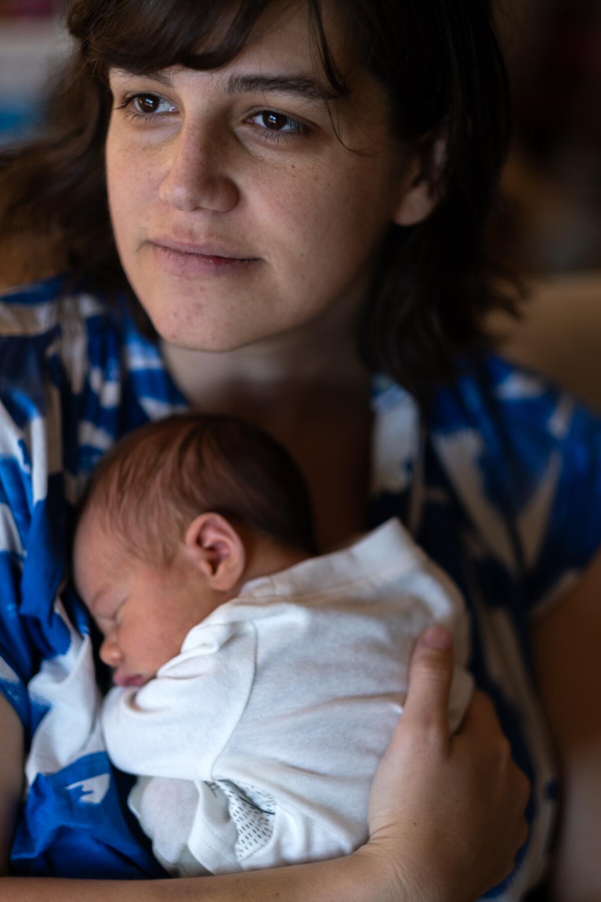 Megan Costello holds her infant son.