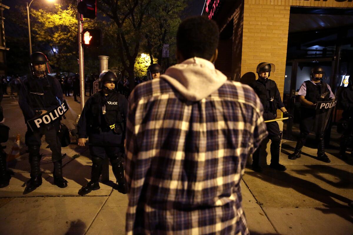 A demonstrator confronts police wearing riot gear during an Oct. 9 protest in the shooting death of Vonderrit D. Myers Jr. by a police officer in St. Louis.